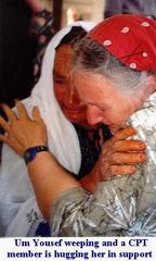 Um Youssef weeping, and a CPT member is hugging her in support