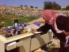 Zuhur Al-Atrash with dresser saved from house before it was demolished