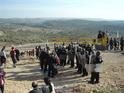 Demonstrators on both sides of a line of soldiers