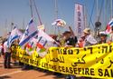 The peace activists demonstrate on the shore