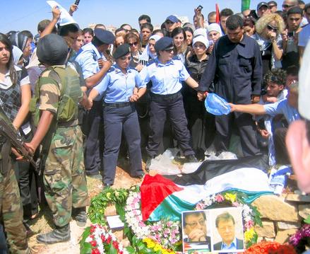 Palestinian policewomen holding the throng back