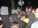 Arab and Jewish protesters hoist the two-flag emblem of Gush Shalom. The poster says: “Jews and Arabs refuse to be enemies!”