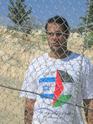 Bassem wearing the Gush shalom shirt with the flags of Israel and Palestine