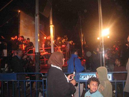 Jews and Arabs listening to speeches in both languages.