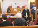 Advocate Gaby Lasky (standing) in the courtroom at the start of  the proceedings